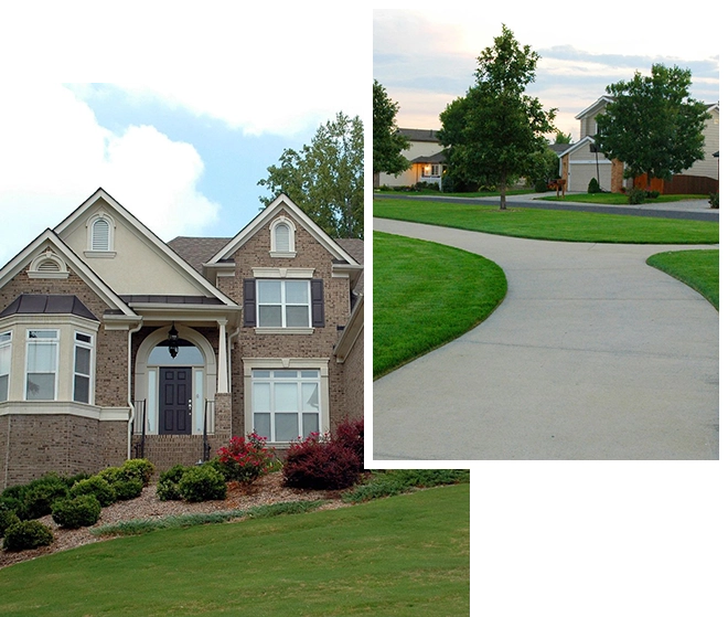 A house and driveway with trees in the background